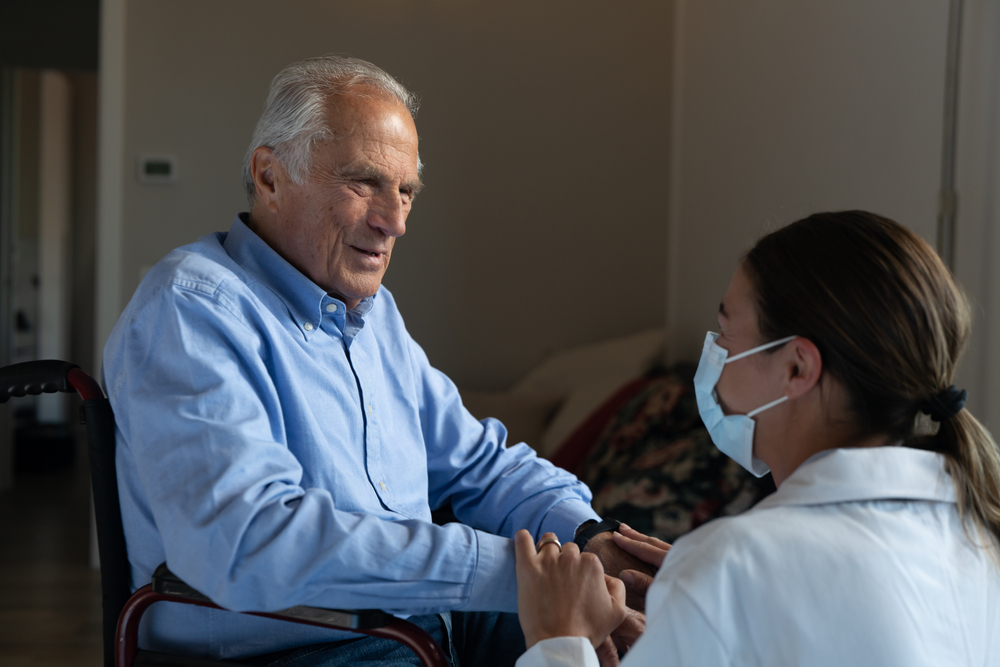 Care Home resident and vaccinated care home worker wearing a mask