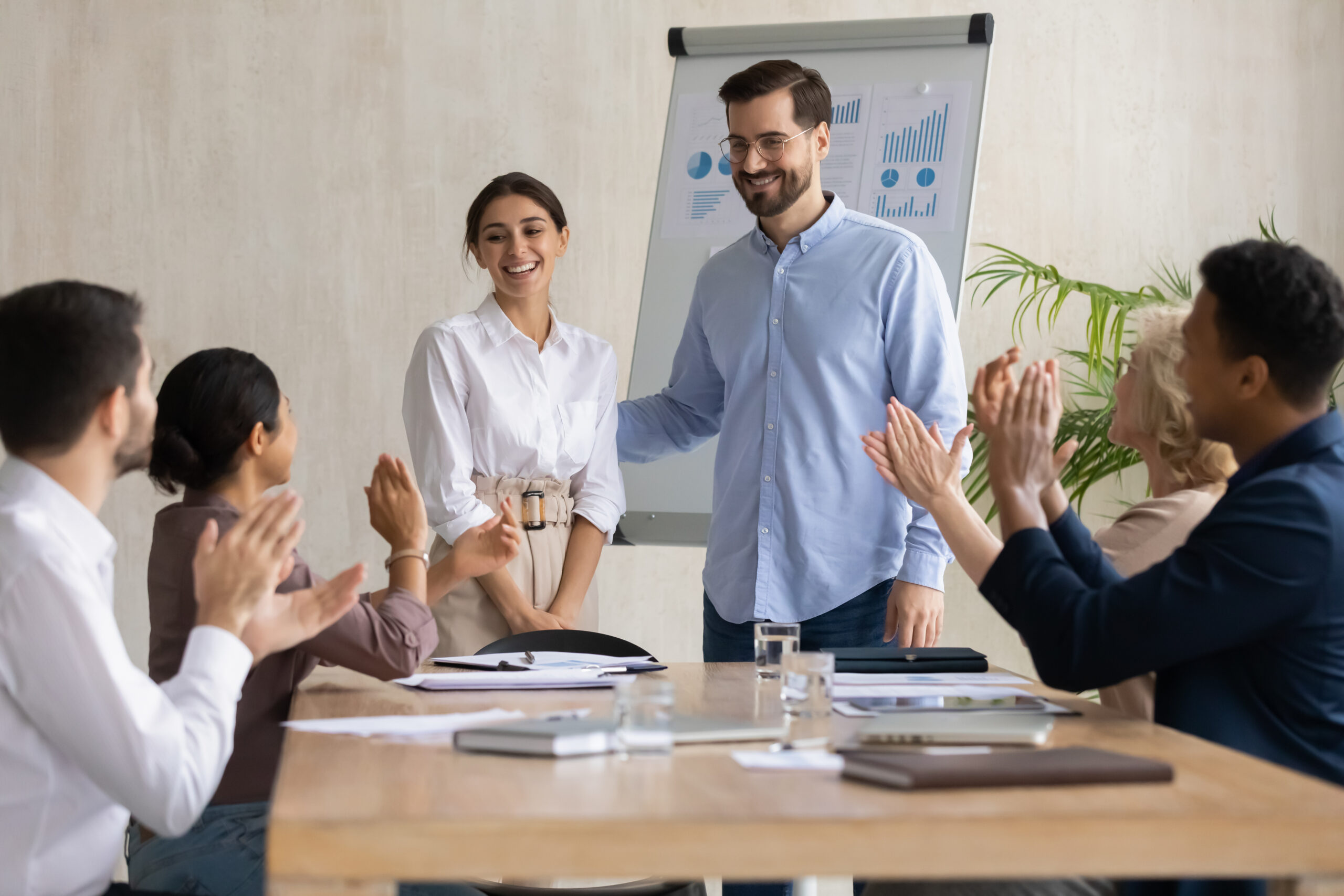 A new employee standing infront of the team during her probation period. Read our guide to probation periods in the UK.